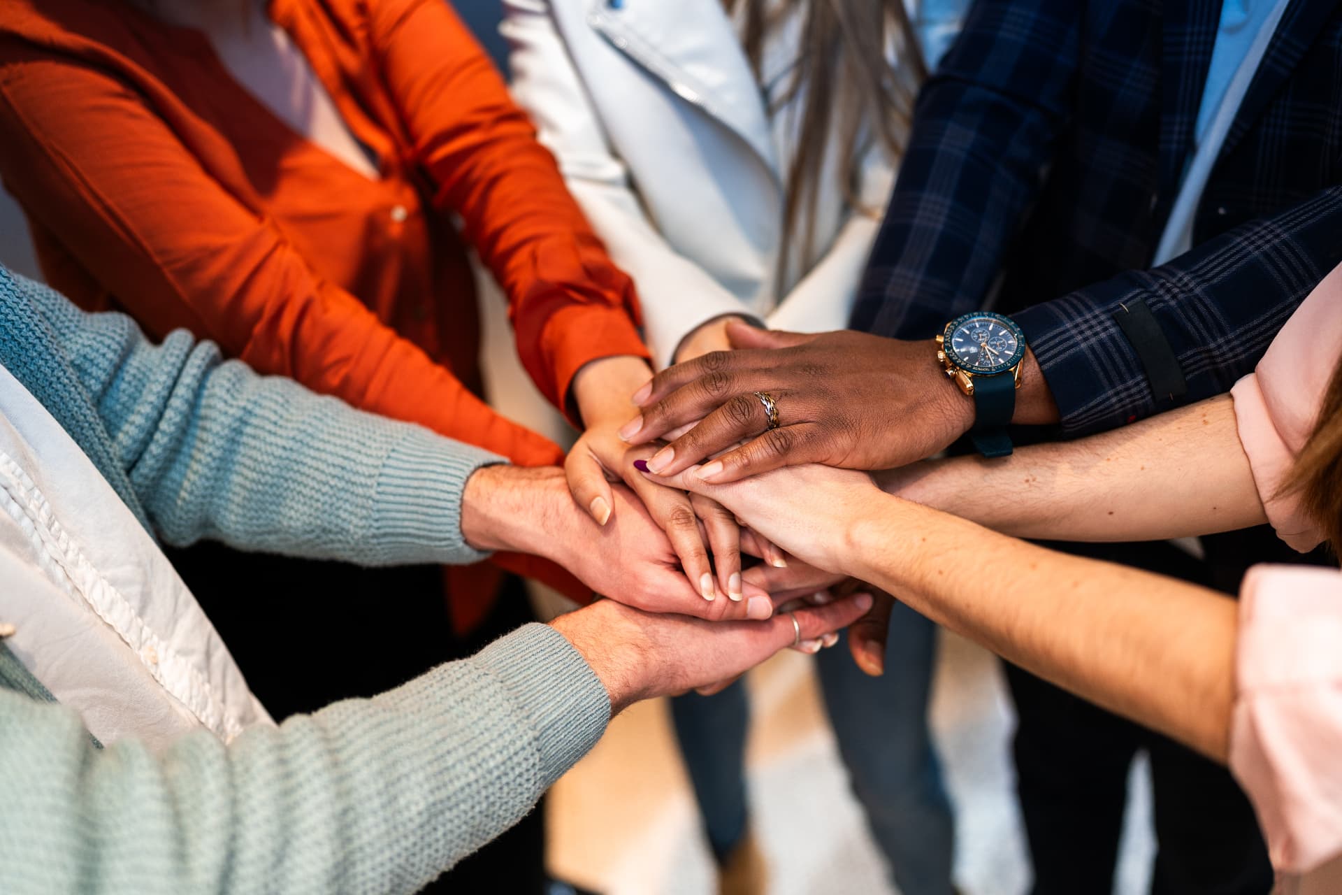 Diverse hands stacked together in support and solidarity